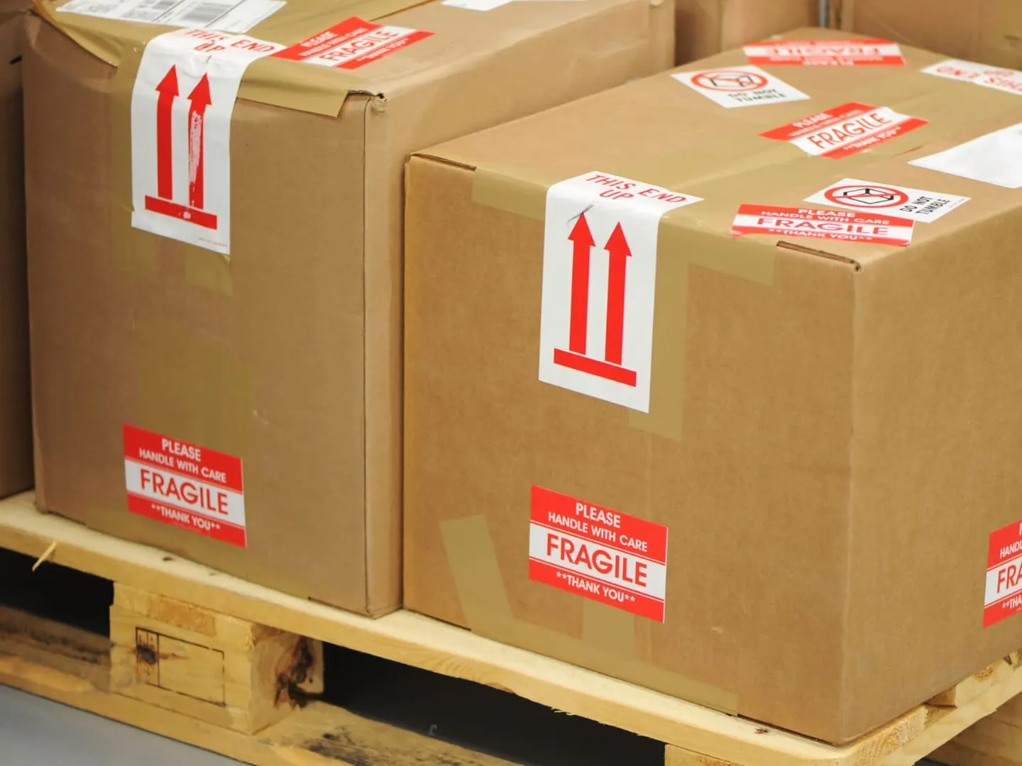 Boxes marked fragile, stacked on a wooden pallet
